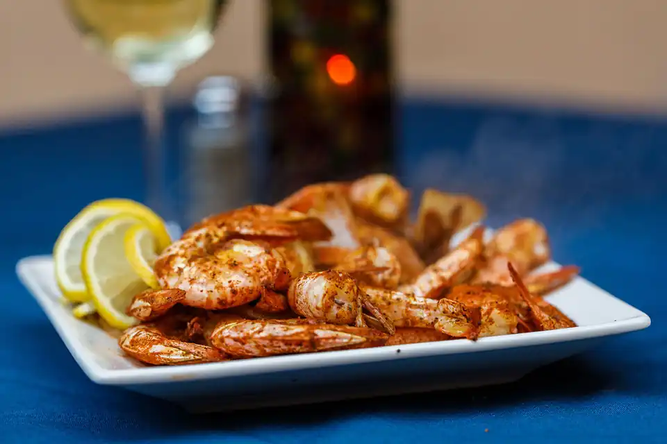 A plate of steamed shrimp with lemon